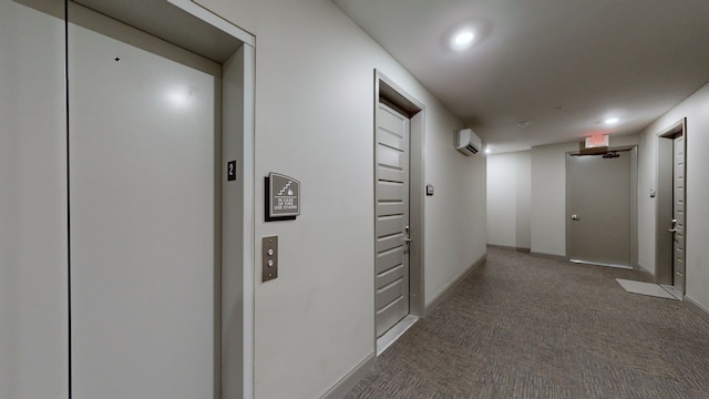 hallway featuring dark carpet, an AC wall unit, and elevator