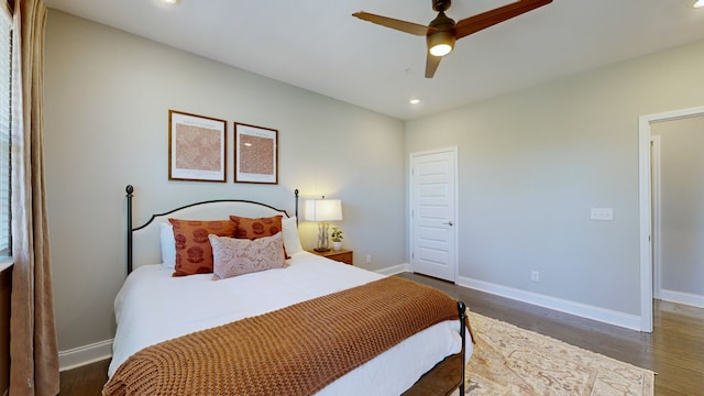 bedroom featuring ceiling fan and dark wood-type flooring