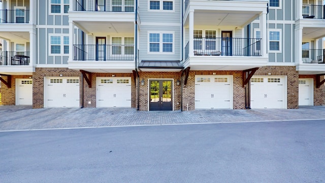 townhome / multi-family property featuring a garage and a balcony