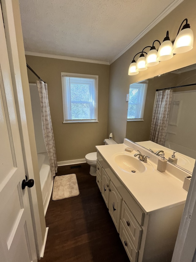 full bathroom featuring vanity, hardwood / wood-style flooring, ornamental molding, toilet, and a textured ceiling