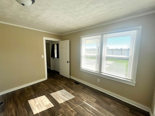 unfurnished room featuring ornamental molding, a textured ceiling, and dark wood-type flooring