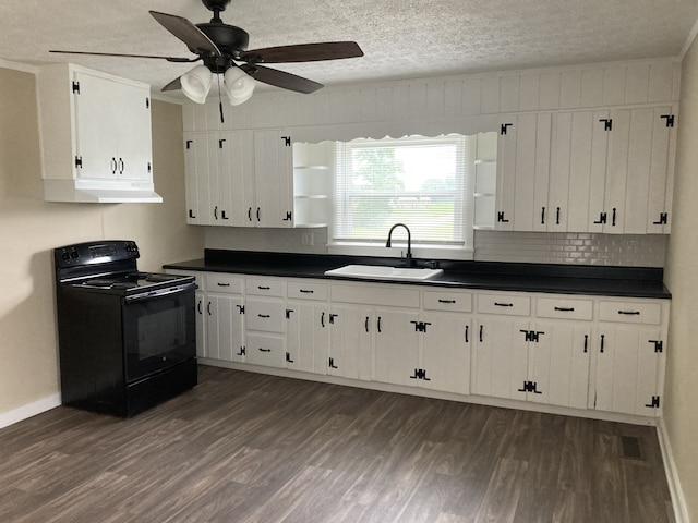 kitchen featuring white cabinets, black electric range, dark hardwood / wood-style flooring, and sink