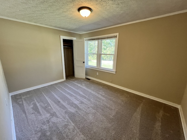 unfurnished bedroom featuring crown molding, a closet, carpet, and a textured ceiling