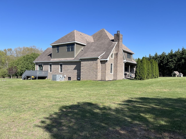 back of house with a yard, central AC, and a deck