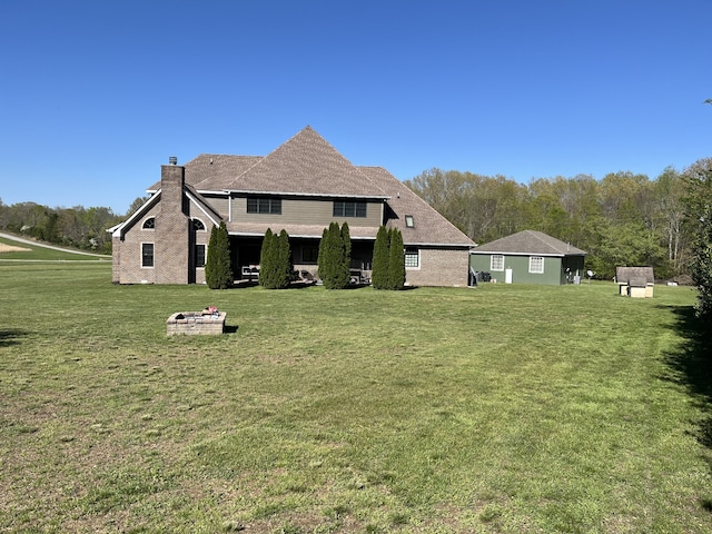 rear view of property featuring a yard