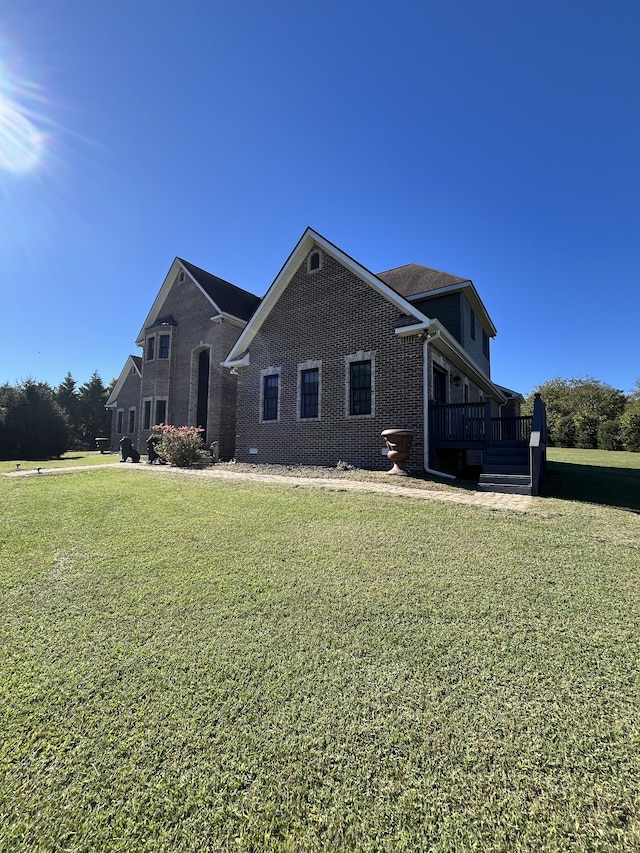 view of front of house featuring a front lawn and a deck