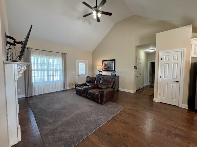 living room featuring dark wood-type flooring, high vaulted ceiling, and ceiling fan