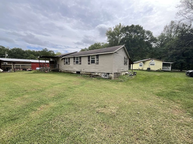 back of house with a lawn