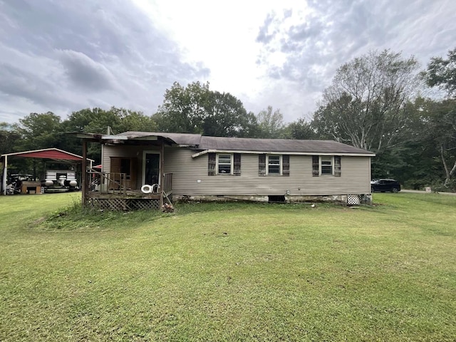 back of property featuring a deck and a yard