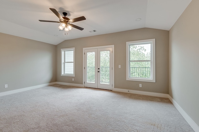 spare room with light carpet, vaulted ceiling, and ceiling fan