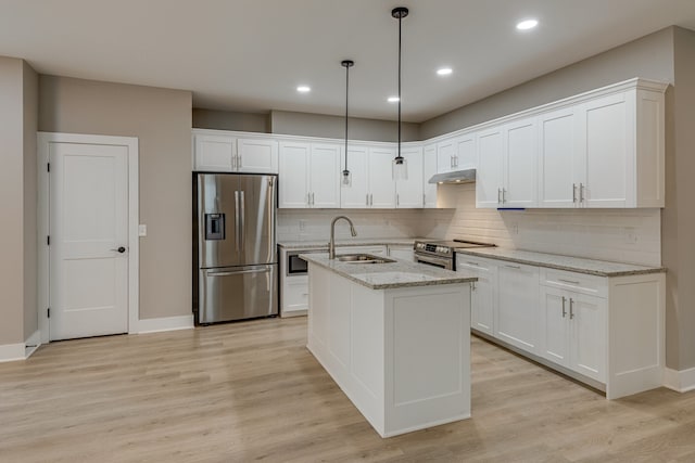 kitchen with white cabinets, stainless steel appliances, sink, and light hardwood / wood-style flooring