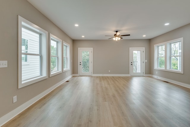 spare room featuring ceiling fan and light hardwood / wood-style flooring