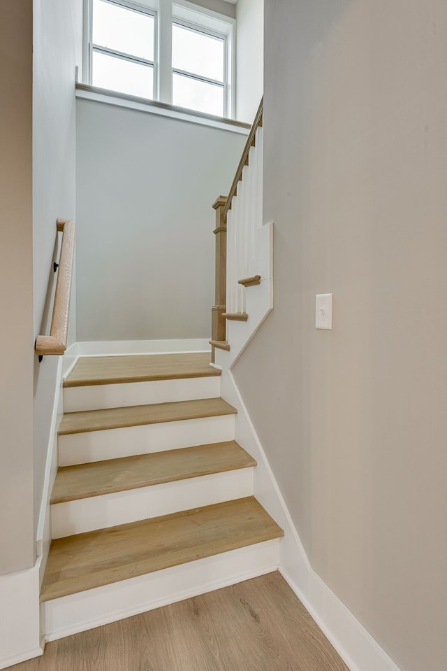 stairs with hardwood / wood-style floors