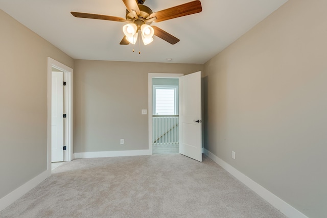 carpeted empty room with ceiling fan