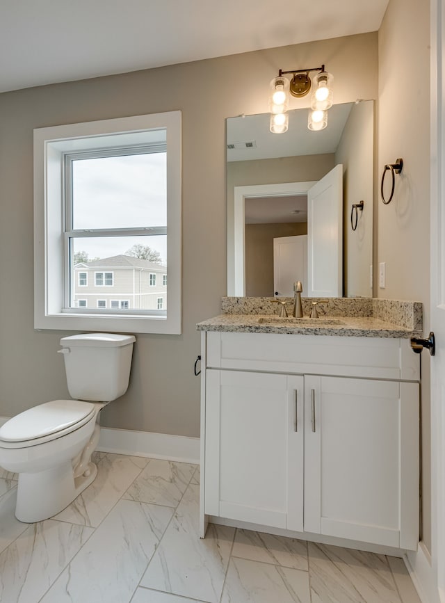 bathroom featuring toilet and vanity