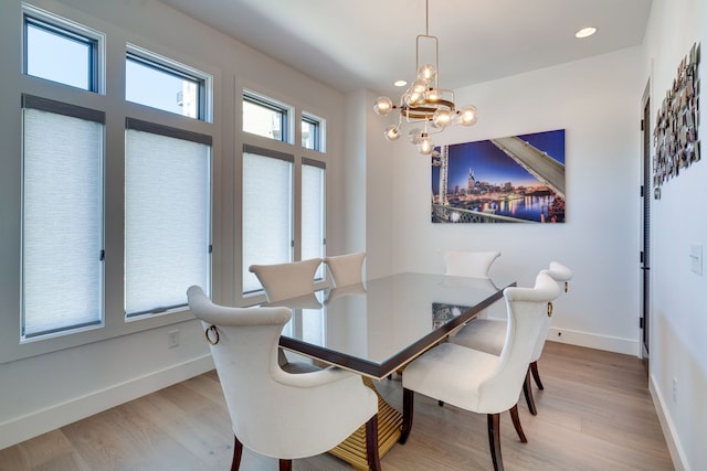 dining area featuring an inviting chandelier and light wood-type flooring