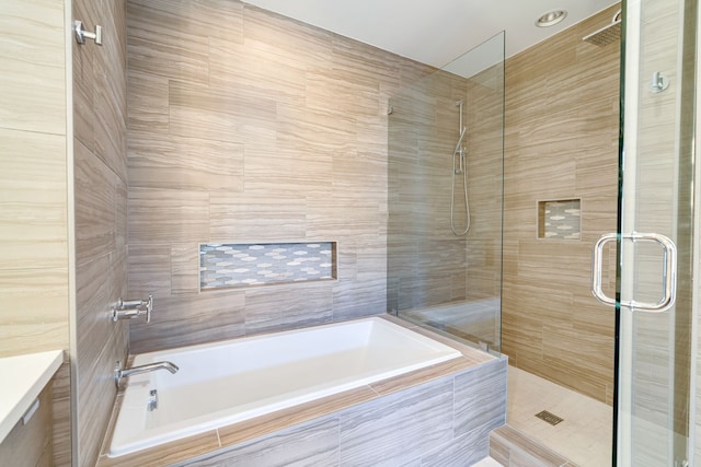 bathroom with shower with separate bathtub