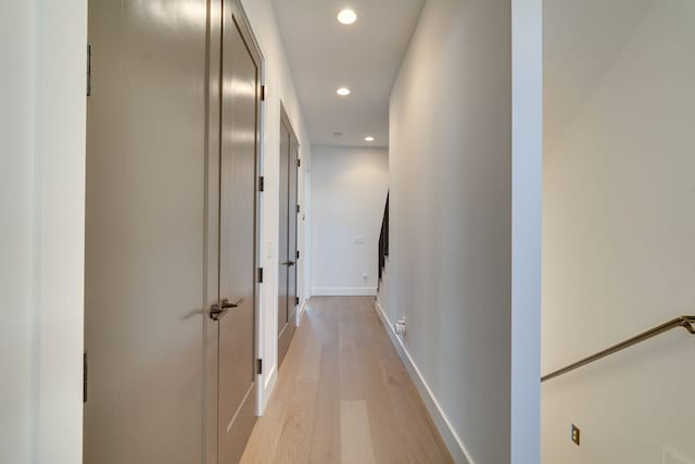 hallway with light hardwood / wood-style flooring