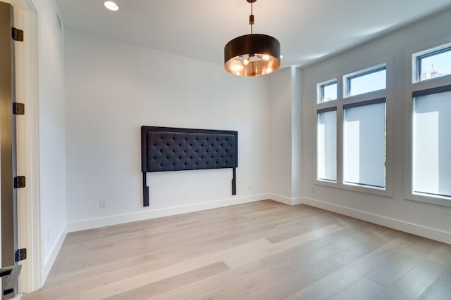 empty room with light hardwood / wood-style flooring