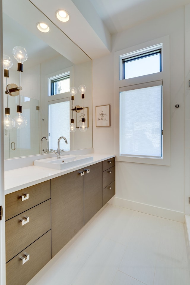 bathroom featuring vanity and an enclosed shower