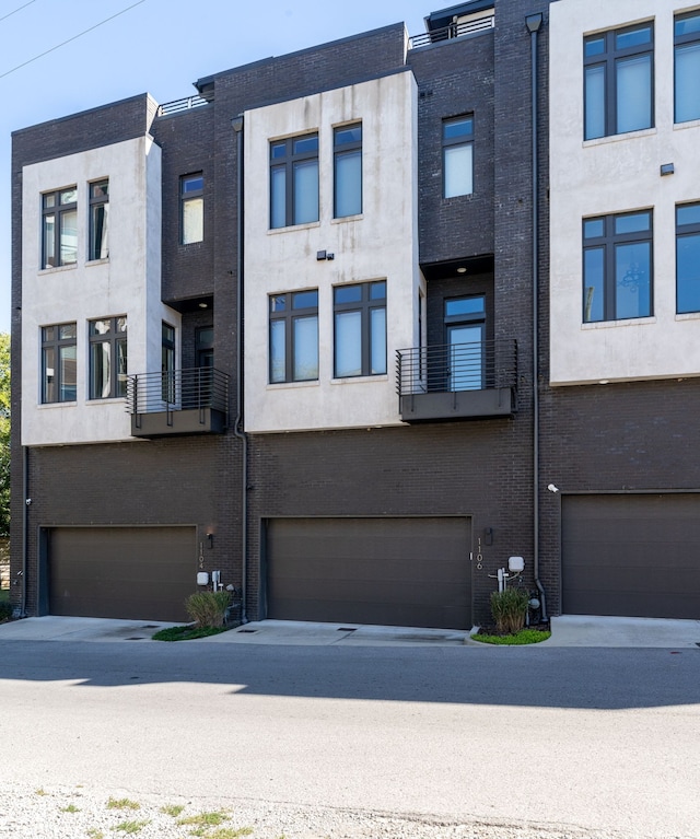 view of front of home featuring a balcony and a garage