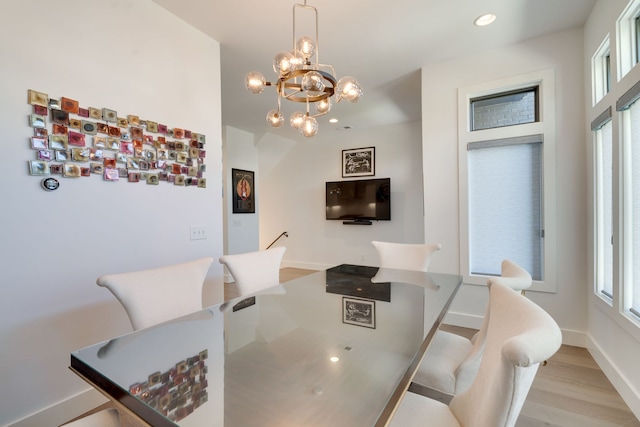 dining room featuring an inviting chandelier and light wood-type flooring