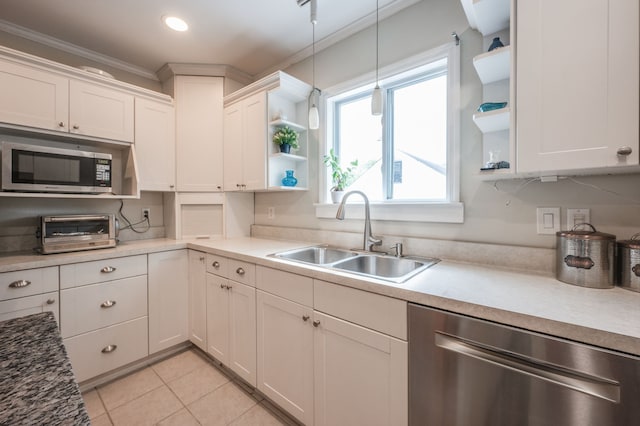 kitchen featuring white cabinetry, sink, appliances with stainless steel finishes, and ornamental molding