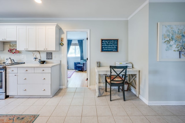 kitchen with white cabinetry, stainless steel electric range, light tile patterned flooring, and crown molding