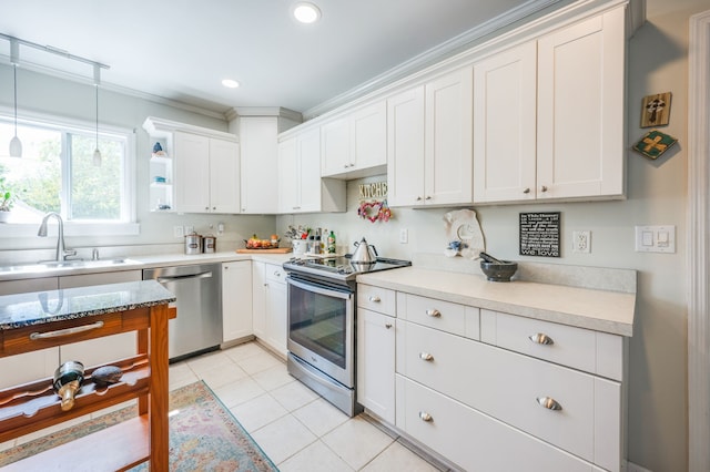 kitchen with white cabinets, sink, ornamental molding, and stainless steel appliances