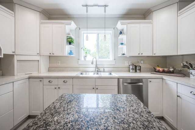 kitchen with dark stone countertops, decorative light fixtures, white cabinetry, and sink