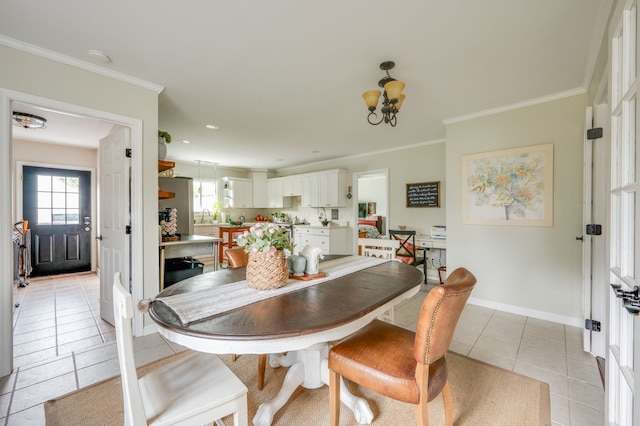 dining space with light tile patterned floors, sink, and ornamental molding