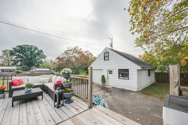 wooden terrace with an outbuilding and outdoor lounge area