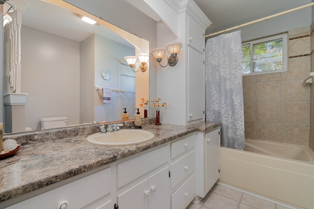 full bathroom featuring shower / bath combo with shower curtain, tile patterned floors, vanity, and toilet