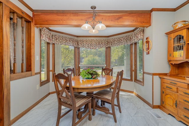 dining space featuring ornamental molding, a notable chandelier, and a wealth of natural light