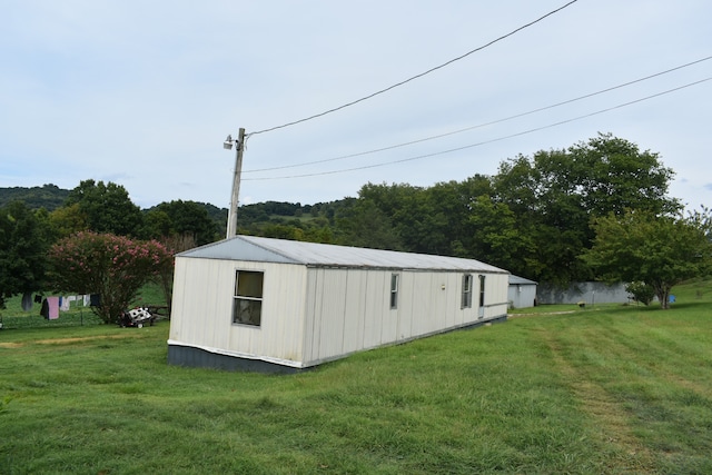 view of outbuilding featuring a yard