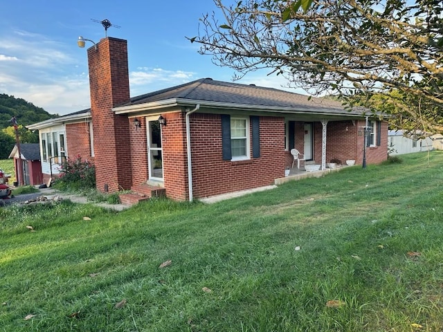 rear view of house featuring a yard