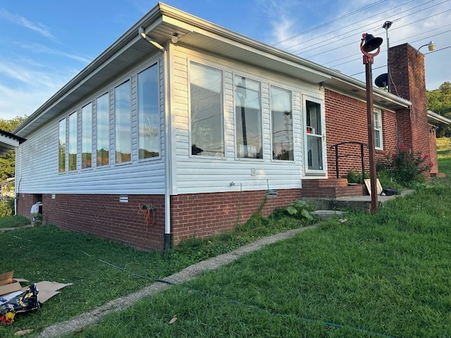 view of property exterior with a lawn