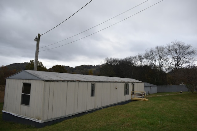 view of outbuilding with a lawn