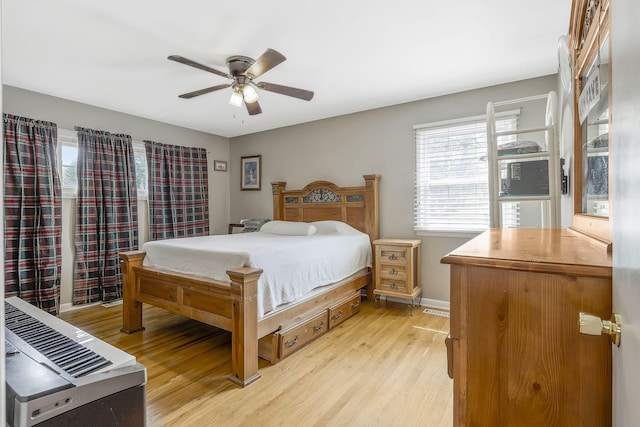 bedroom with ceiling fan and light hardwood / wood-style floors