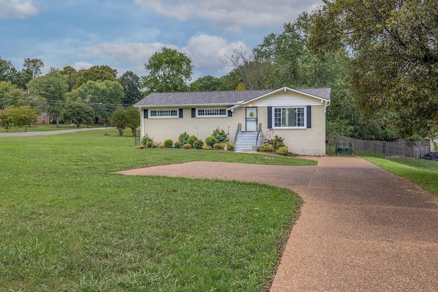 ranch-style home featuring a front yard