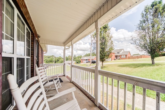 wooden deck with a yard and covered porch