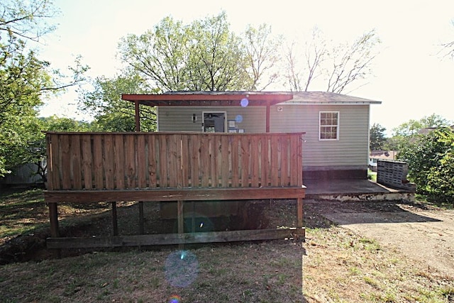 rear view of house featuring a deck