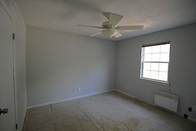 carpeted spare room with a textured ceiling and ceiling fan