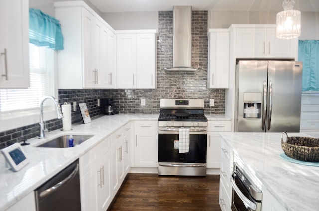 kitchen with stainless steel appliances, white cabinets, sink, dark hardwood / wood-style flooring, and wall chimney range hood