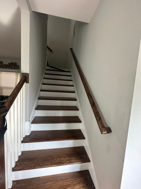 stairway with hardwood / wood-style floors