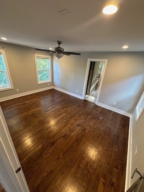 spare room featuring ceiling fan, vaulted ceiling, and dark hardwood / wood-style floors