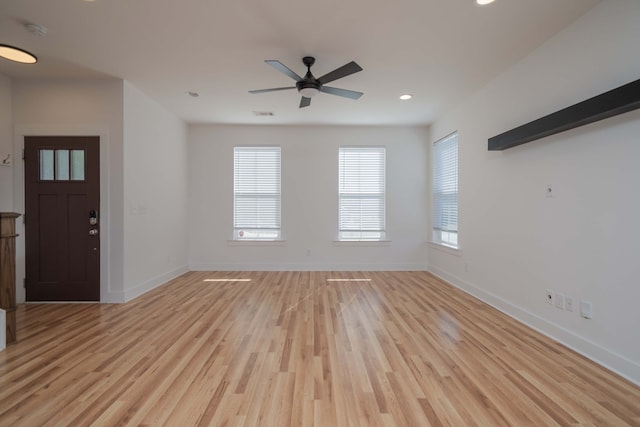 unfurnished living room with ceiling fan, a healthy amount of sunlight, and light hardwood / wood-style flooring