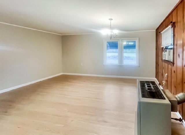 spare room featuring baseboards, plenty of natural light, and a chandelier