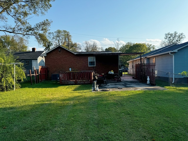 back of house with a patio, a yard, a deck, and central AC unit