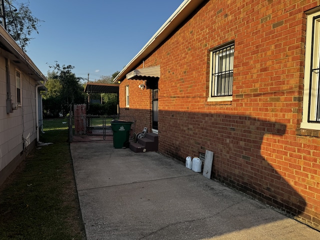 view of property exterior with a patio area